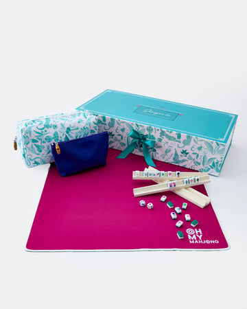 Marble-patterned box with a blue pouch, pink mat, and game pieces on a white background