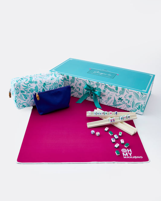 Marble-patterned box with a blue pouch, pink mat, and game pieces on a white background